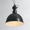 Black Industrial Pendant Light Featuring Round Dome Shade and Warm Light on White Brick Wall