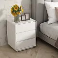 Stylish White Three Drawer Nightstand In Bedroom With Vase Yellow Flowers And Photo Frames