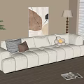 Plush Beige Three Seater Sofa With Decorative Pillows Side Table And Lamp