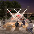 Outdoor Stage Scene With Bright Lights People On Wooden Crate Seats And City Night View