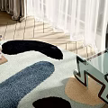 Light Blue Accent Chair with Colorful Shaped Rug Wooden Floor Stacked Books and White Curtains