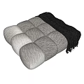 Modern Upholstered Ottoman with Round Tufted Design and Cozy Striped Blanket alongside Decorative Balls