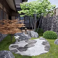 Rockery Stones in Japanese Garden with Stone Lanterns Wooden Fence Maple Trees and Mossy Pathway