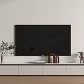 Modern White TV Stand In Living Room With Black TV Plant And Decorations