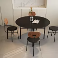 Minimalist Round Black Wooden Dining Table Set With Four Wooden Backrest Black Seat Chairs And Simple Vase Decoration