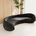 Black Curved Sectional Sofa In Modern Space With Wooden Wall And Green Plant