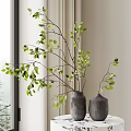 Gray Vases Holding Green Leaf Branches Placed on Table with Curtain and Natural Light