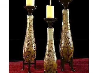 Three Elegant Vase Shaped Candle Lamps With Floral Patterns And Black Bases On Red Cloth 3d model