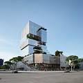 Modern Multi Storey Office Building With Glass Curtain Wall And Green Plants In Urban Environment