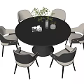 Round Black Dining Table Set with Six Gray White Chairs Green Plant Magazine and Vase