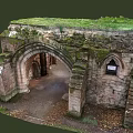 Ancient Stone Ruins Featuring Arched Doorway And Moss Covered Historical Walls