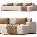 Cozy Beige Fabric Sectional Sofa With Brown Pillows And Throw Blanket