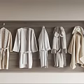 Cozy Neutral Robes With Soft Fabric And Belts Hanging In Wardrobe