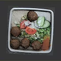 Delicious Falafel Balls With Fresh Vegetables Salad And Sauce In Square Container