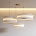 Three Modern White Pendant Lights With Striped Design Hanging From Ceiling In Interior