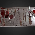 Various Medical Surgical Instruments on Stainless Steel Tray with Blood Stains