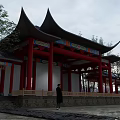 Traditional Ancient Chinese Architecture With Red Pillars Curved Eaves And Colorful Paintings Near Trees