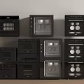 Various Black Kitchen Appliances Stacked Against Light Wall With Wooden Countertop