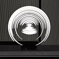 Modern Circular Illuminated Sculpture With Transparent Design And Striped Wall Background