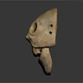 Ancient Clay Mask Featuring Prominent Eye Holes And Primitive Facial Design