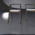 Two Stylish Wooden Chairs with White Cushions and Curved Armrests on Gray Background