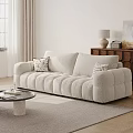 Beige Three Seater Sofa With Accent Pillows Coffee Table And Wooden Cabinet