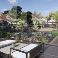 Rockery Stones In Serene Garden With Pond Surrounding Trees Pavilion And Outdoor Sofa