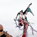 Woman Dancing In Traditional Costume With Flowing Ribbons And Instrument Against Mountain Clouds