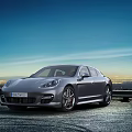 Sleek Gray Porsche Panamera On Open Road At Dusk
