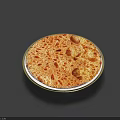 Round Golden Brown Pizza on a Plate with Small Holes and Brown Spots on Surface