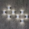 Multiple Modern White Square Wall Lamps Illuminating Textured Concrete Wall