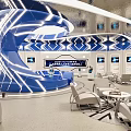 Modern Exhibition Hall With Curved Blue Lighting Display Screens Geometric Patterns And Seating