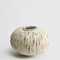 Round Cream Colored Ceramic Vessel With Textured Surface And Yellow Blue Accents