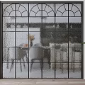 Modern Interior Design Featuring Black Metal Frame Textured Glass Room Divider And Dining Space