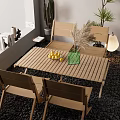 Wooden Table and Chair Set in Outdoor Balcony With Pebble Floor Green Vase and Cactus