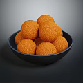 Crispy Orange Food Balls Served in Black Bowl with Crumbly Surface Texture