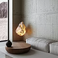 Illuminated Stone Shaped Decorative Lamp In Modern Living Room With Concrete Wall And Sofa