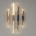 Modern Metal Wall Lamps In Gold Black On Light Colored Wall With Soft Glowing Light
