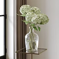 Clear Glass Vase With White Hydrangea Flowers On Metal Table Near Window