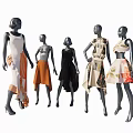 Fashion Mannequins Displaying Various Stylish Dresses Against Blue Sky With White Clouds