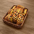 Fresh Baked Pastry Rolls with Patterned Crust in Wicker Basket on Wooden Tabletop