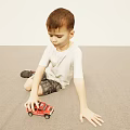 Little Boy Wearing White T-Shirt and Plaid Shorts Playing with Red Toy Car on Floor