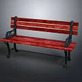 Red Wooden Park Bench With Black Metal Armrests In Natural Setting