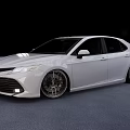 White Toyota Sedan With Modified Alloy Wheels And Sporty Exterior Look