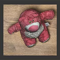 Red Plush Stuffed Bear Toy Sitting On Wooden Platform With Gray Background