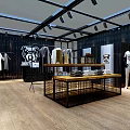 Modern Black Container Clothing Store With Glass Windows Orange Logo And Surrounding Railings