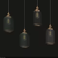Modern Glass Pendant Lights With Green Transparent Shades And Gold Metal Accents Illuminated