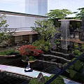 Serene Garden Landscape with Waterfall Pond Red Maple Trees Traditional Pavilion and Lush Green Shrubs