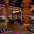 Modern Chinese Restaurant Interior With Neon Lights Wine Bottle Tower Tables Chairs And Green Plants