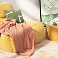 Yellow Bean Bag Chair with Green Pillow Pink Blanket and Ottoman in Cozy Room